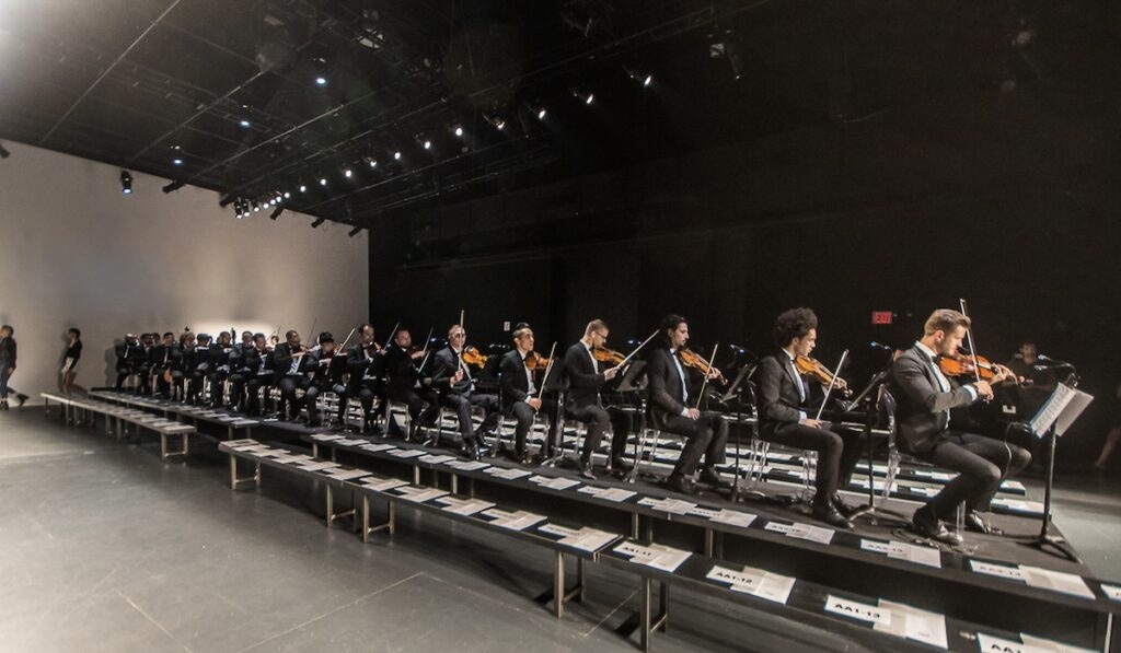 Kiral Artists Male String Orchestra performing live at New York Fashion Week, adding an elegant musical touch to a high-fashion event in NYC